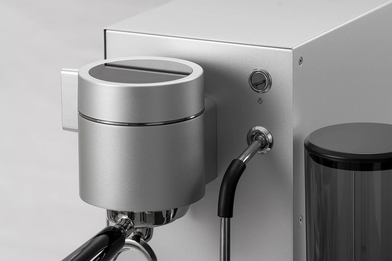 Close-up of a WPM PRIMUS silver coffee machine with a silver spout and black handle on a white background