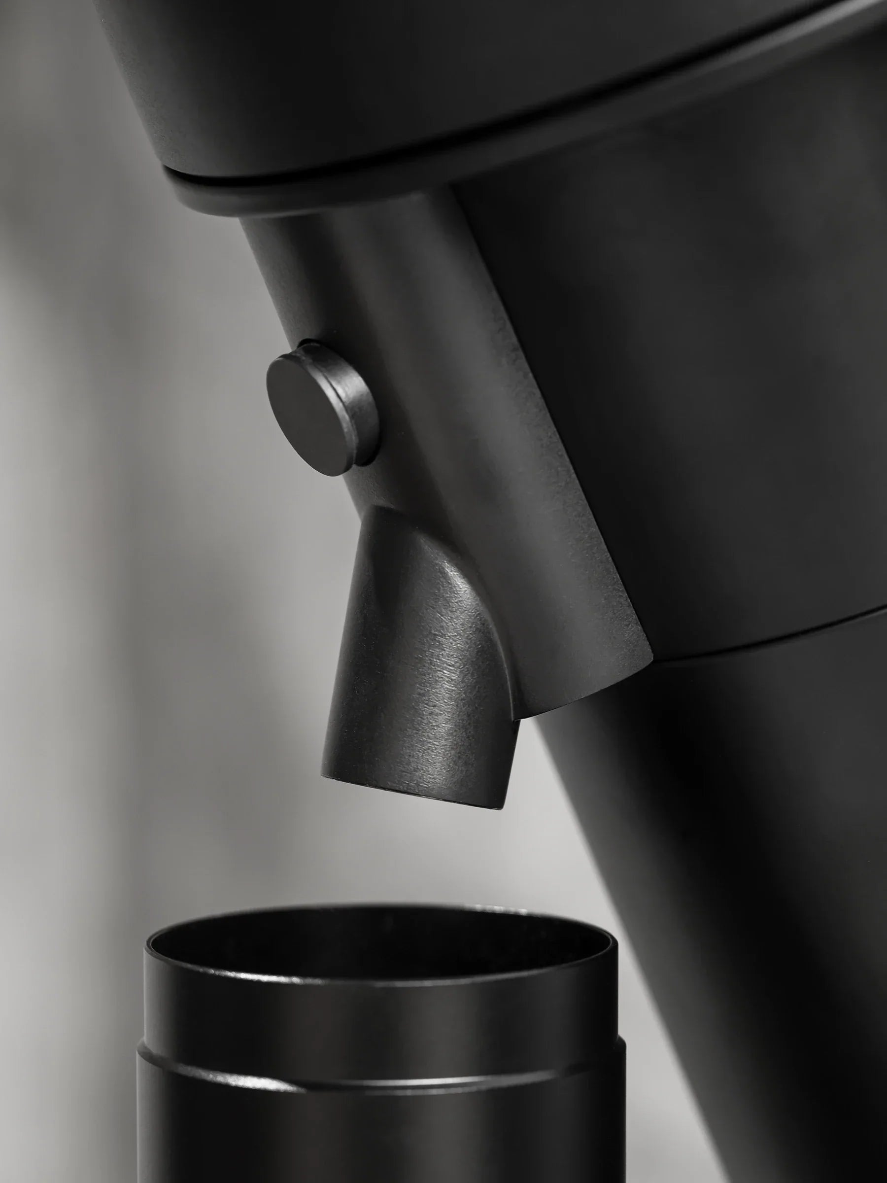 Close-up of the WPM ZP1 Single Dose Grinder's dosing spout and hopper design.