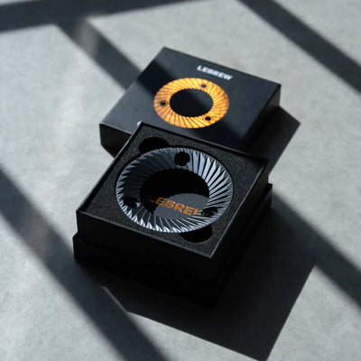 64mm flat burrs displayed in a sleek black box with an orange and black design for optimal brewing performance.