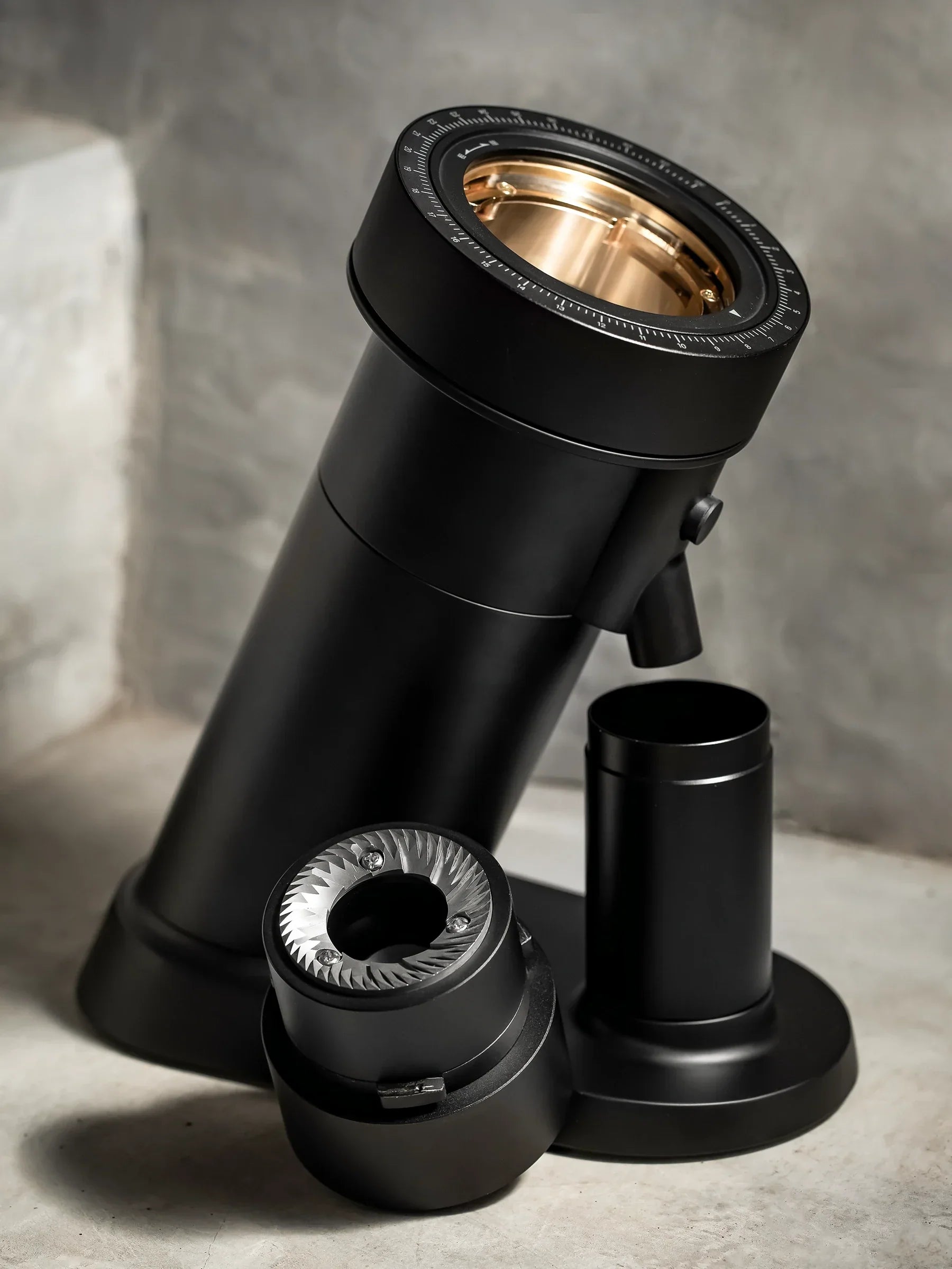 WPM ZP1 Single Dose Grinder showcasing sleek black design and precision components in a modern setting.